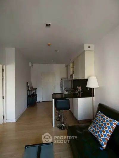 Modern open-layout apartment with sleek kitchen and cozy living area.