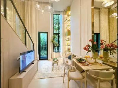 Luxurious modern living room with high ceilings, elegant decor, and large windows overlooking greenery.