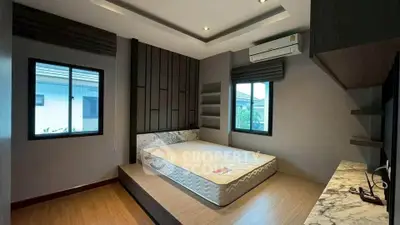 Modern bedroom with platform bed and large windows in stylish home