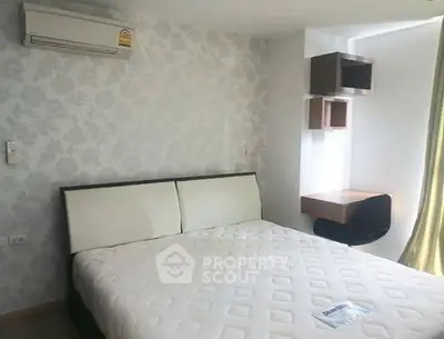 Modern bedroom with stylish wallpaper and air conditioning in a cozy apartment.