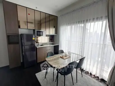 Modern kitchen with dining area and large windows for natural light