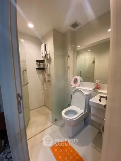 Modern bathroom with glass shower and sleek fixtures in a contemporary home.