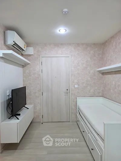 Cozy minimalist bedroom with TV and air conditioning, perfect for modern living.