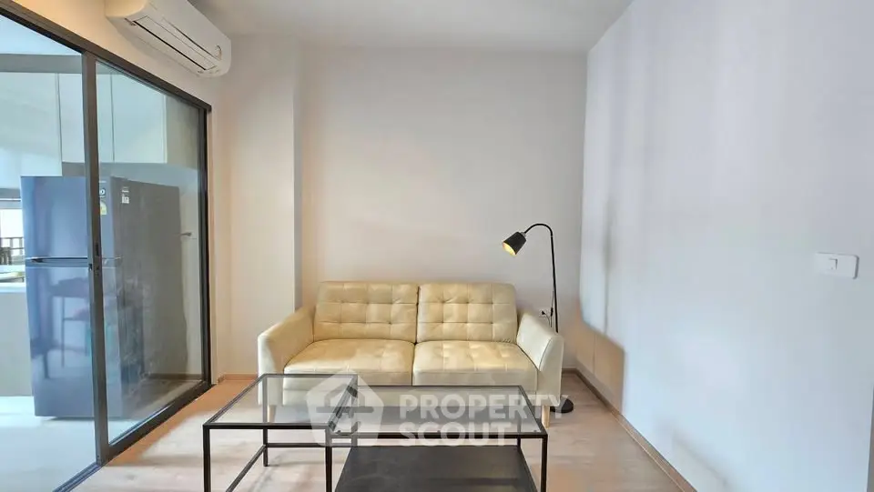 Modern living room with glass door to balcony and sleek furniture