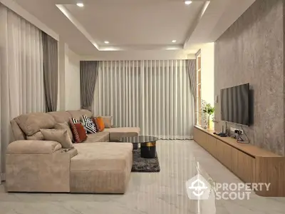 Luxurious modern living room with elegant decor and spacious seating area.