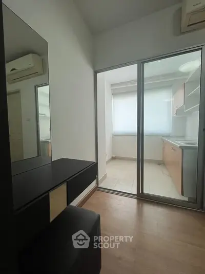 Modern apartment with sleek kitchen and sliding glass doors, perfect for urban living.