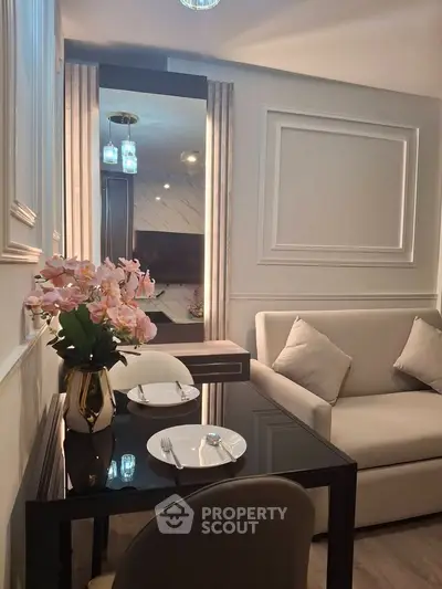 Chic modern living room with elegant dining setup and plush seating, perfect for cozy gatherings.