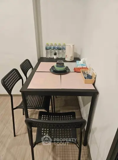 Cozy dining area with modern black table and chairs, perfect for small spaces.