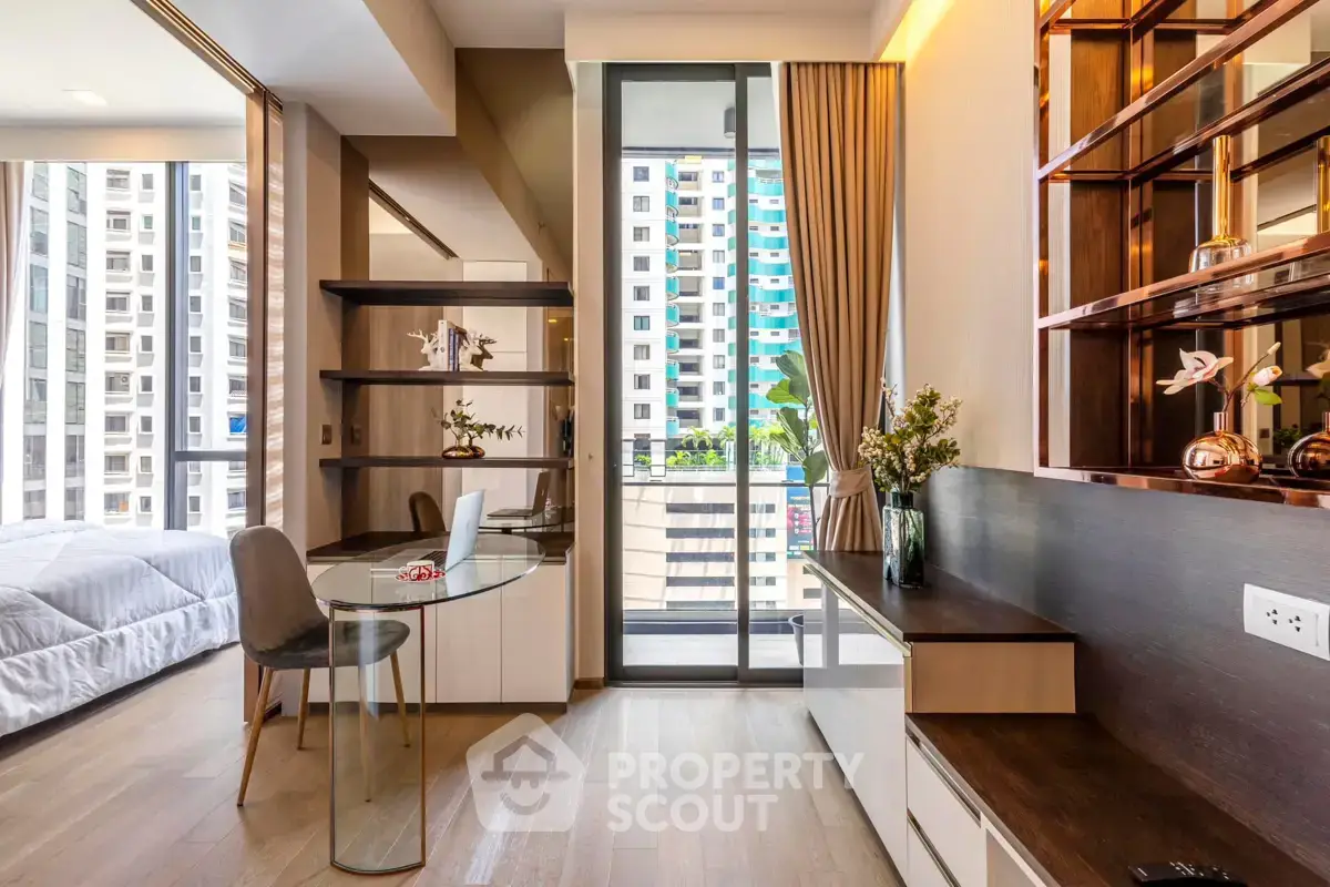 Modern apartment interior with stylish decor and balcony view in urban setting.
