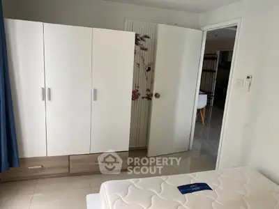 Spacious bedroom with modern wardrobe and comfortable mattress in bright apartment.