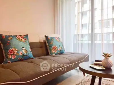 Chic living room with stylish sofa and vibrant cushions, perfect for modern urban living.