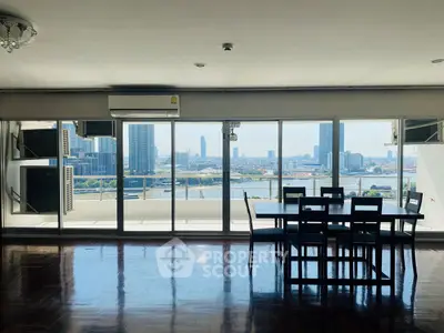Spacious living room with stunning city view and large balcony access.