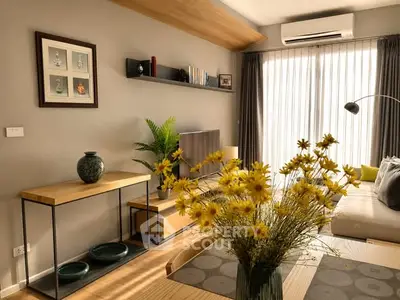 Stylish living room with modern decor, large window, and elegant furniture.