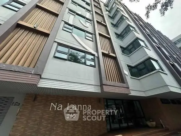 Modern apartment building exterior with unique architectural design and large windows.