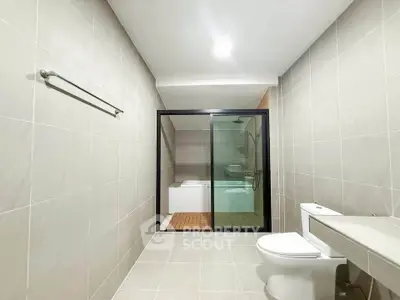 Spacious modern bathroom with sleek design and bathtub, perfect for relaxation.