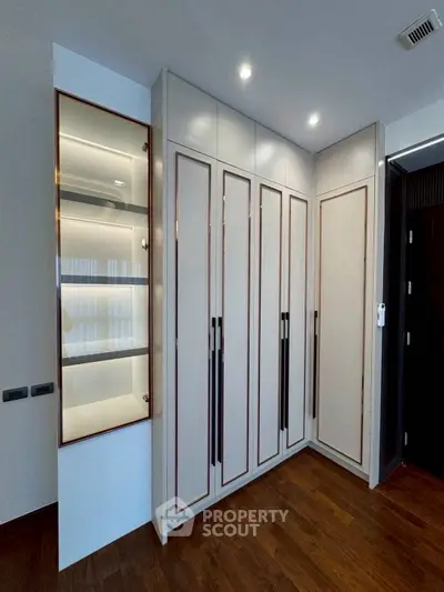Elegant modern storage with sleek cabinetry and wooden flooring