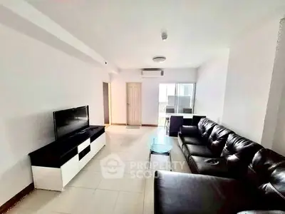Spacious living room with modern leather sofa and sleek TV unit