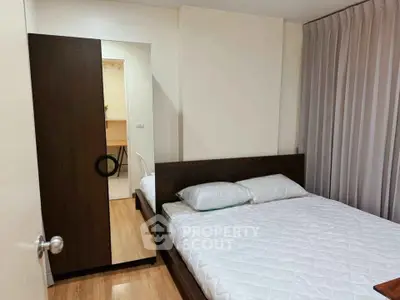 Cozy bedroom with modern furnishings and wooden flooring, perfect for restful nights.