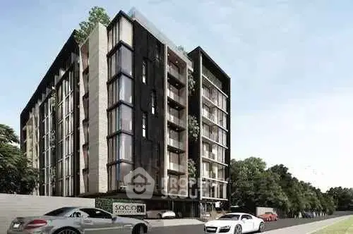 Modern apartment building with sleek design and luxury cars parked outside.