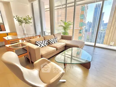 Luxurious living room with stunning city view and modern furniture in high-rise apartment.