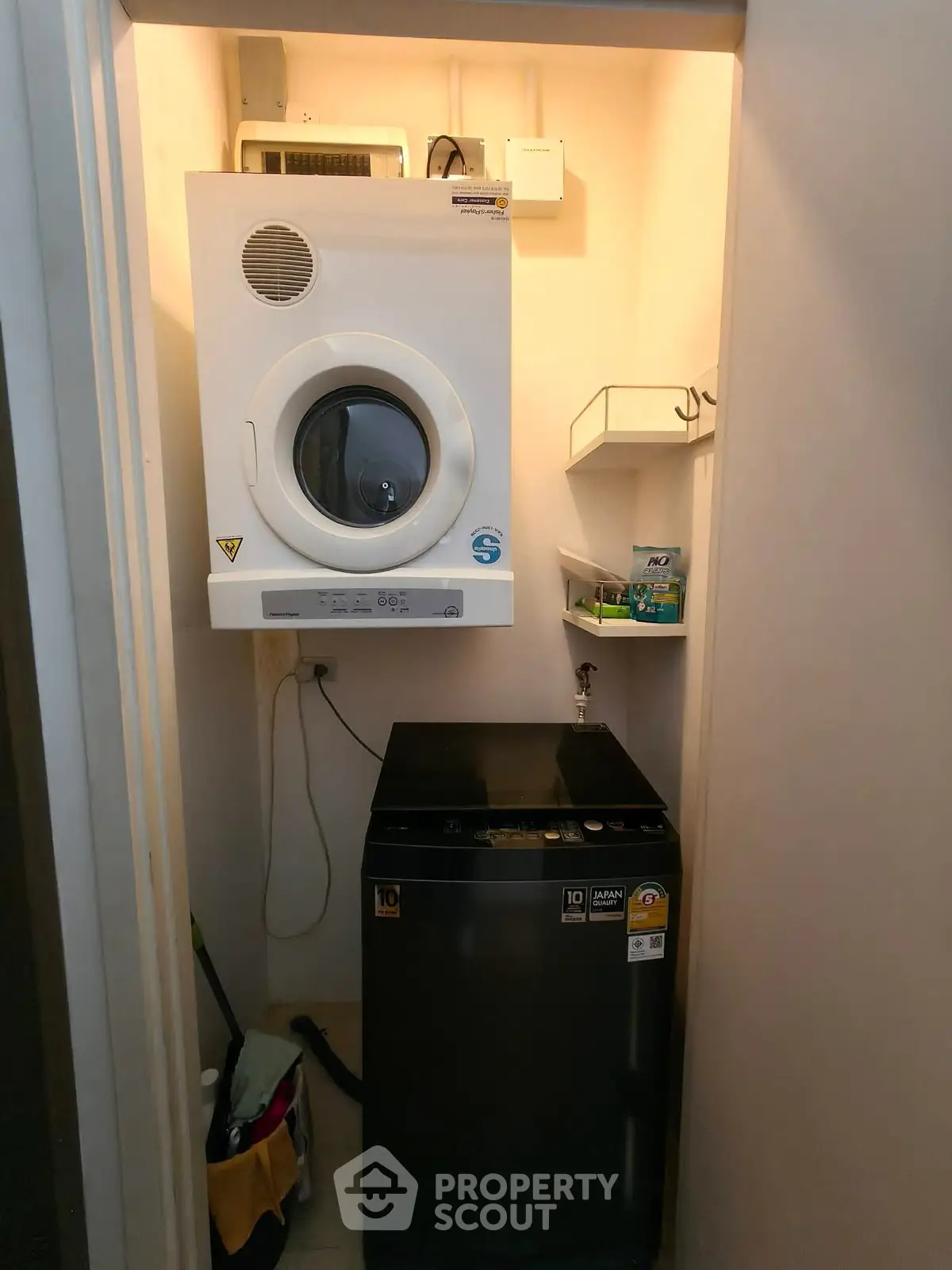 Compact laundry area with modern washer and dryer in cozy home setting.