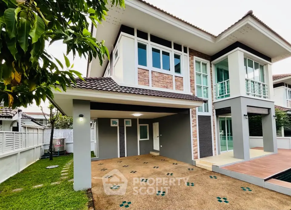 Modern two-story house with spacious driveway and lush garden