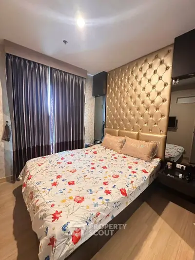 Luxurious bedroom with elegant decor and plush bedding in modern apartment.