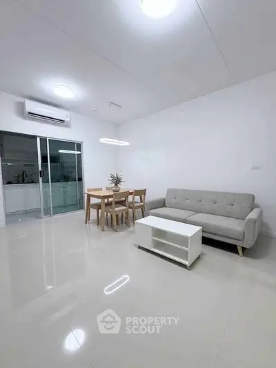 Modern living room with sleek furniture and open kitchen layout