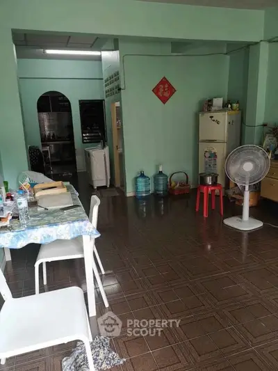 Cozy dining area with fan and fridge in open layout kitchen
