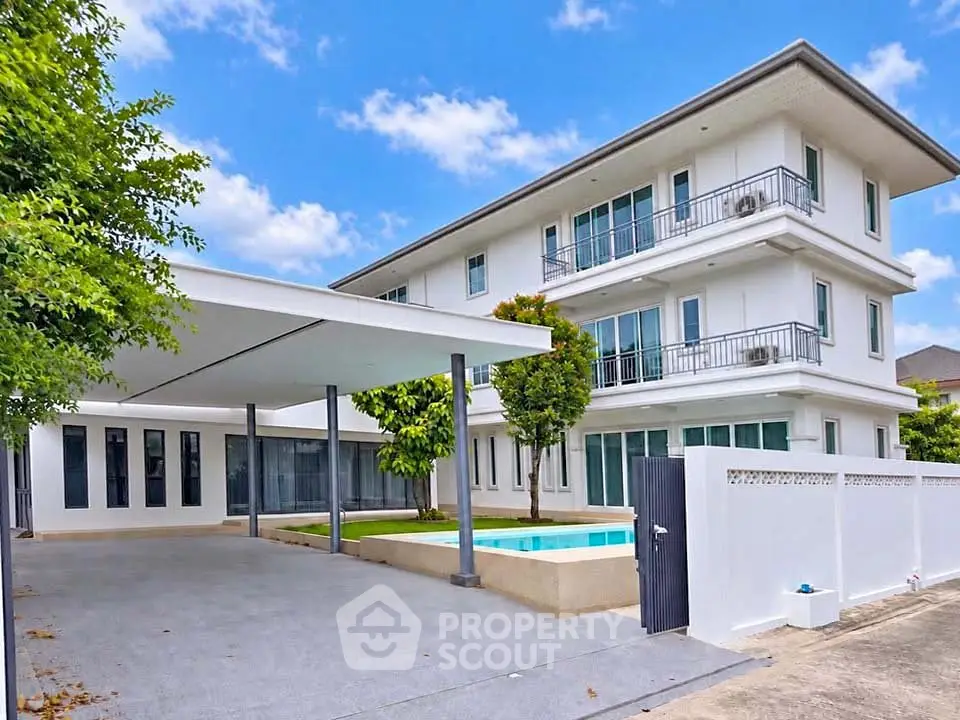 Stunning modern three-story house with pool and spacious driveway, perfect for luxurious living.
