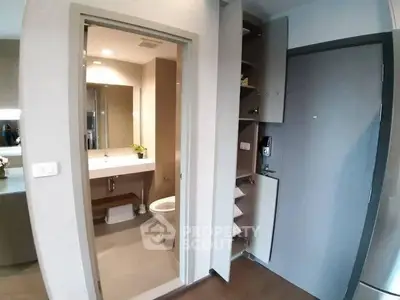 Modern bathroom with sleek design and open storage in a contemporary apartment.