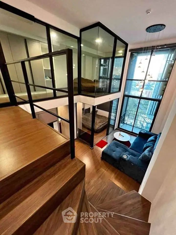 Stunning modern duplex with floor-to-ceiling windows and stylish staircase in urban setting.