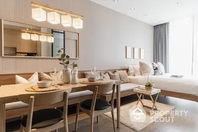 Elegant studio apartment with seamless living and dining area, modern furniture, and tasteful decor, perfect for urban living.