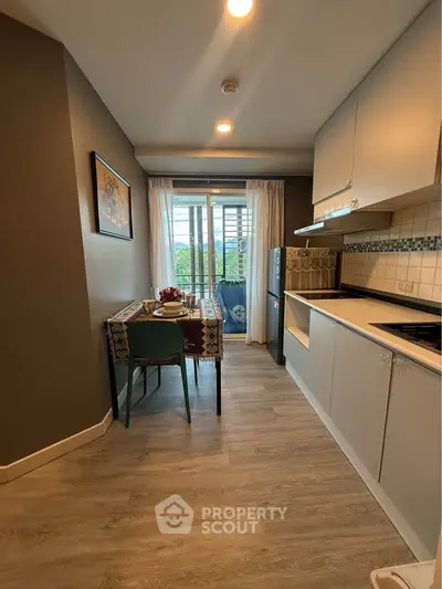 Modern kitchen with dining area and balcony view in stylish apartment