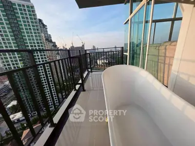 Luxurious balcony with bathtub offering stunning city views in modern high-rise apartment.