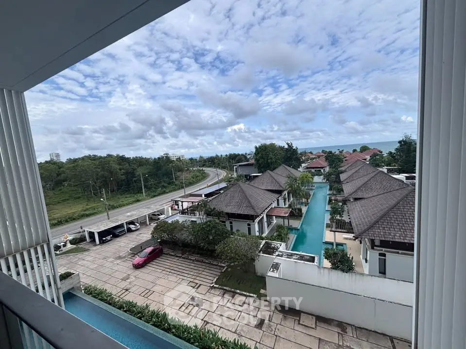 Stunning view of luxury villas with private pools and ocean backdrop, perfect for serene living.