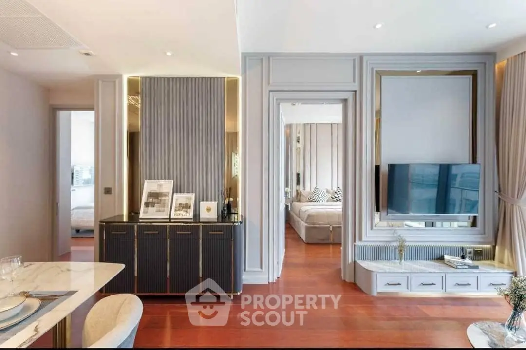 Elegant open-plan living space with modern furnishings, sleek hardwood flooring, and a seamless flow into a cozy bedroom area, perfect for upscale urban living.