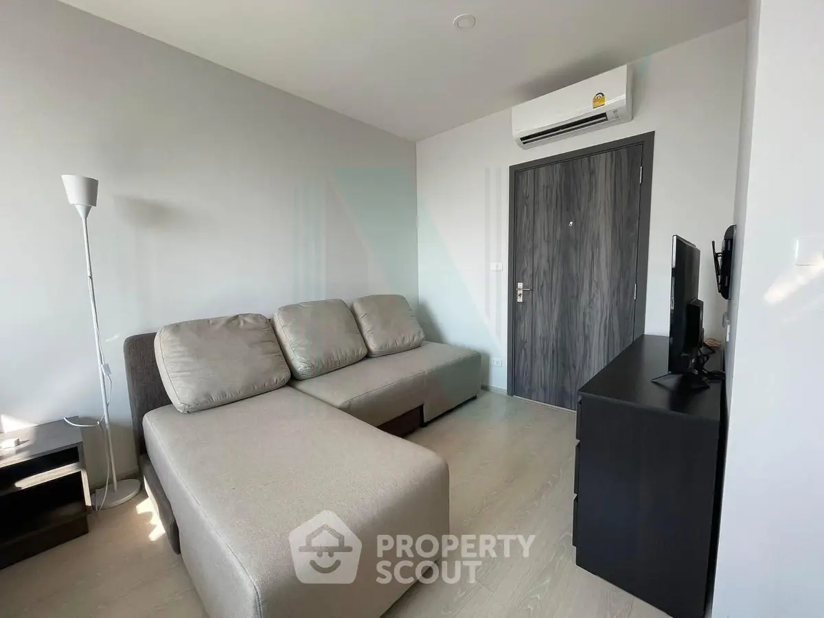 Modern living room with sleek furniture and air conditioning in a stylish apartment.