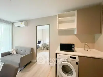 Modern apartment interior with washing machine and cozy living area