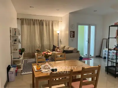 Cozy living and dining area with natural light and modern decor