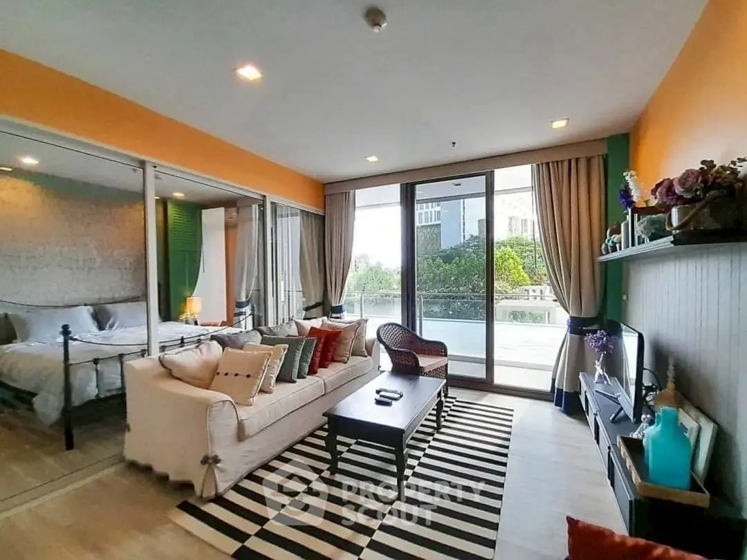 Stylish living room with balcony view, modern decor, and cozy ambiance.