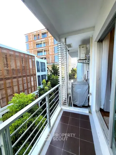 Modern balcony with sleek railing and lush greenery view