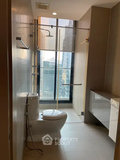 Modern bathroom with city view, featuring sleek shower and toilet design.
