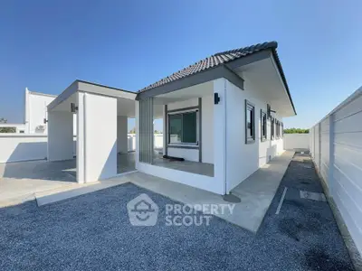 Modern single-story house with sleek design and spacious outdoor area, perfect for family living.
