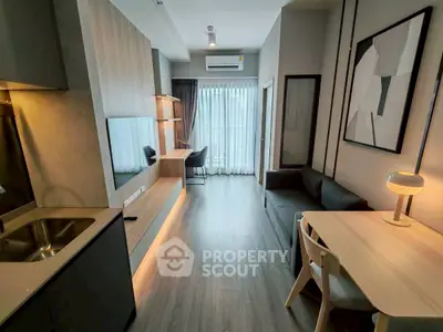 Modern living room with sleek design and natural light, featuring a cozy sofa and stylish decor.