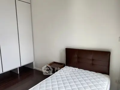 Modern minimalist bedroom with sleek wardrobe and stylish bed frame.