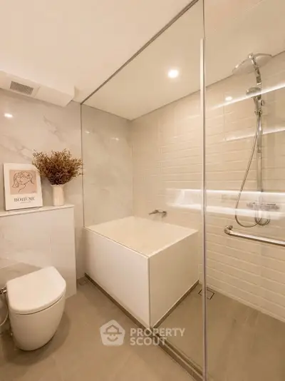 Modern bathroom with sleek design, featuring a built-in bathtub and elegant tile work.