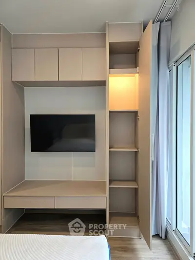 Modern bedroom with built-in storage and wall-mounted TV