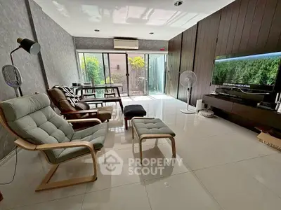 Spacious modern living room with sleek furniture and large windows for natural light.