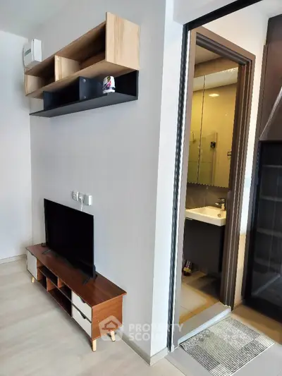 Modern apartment interior with TV stand and bathroom view